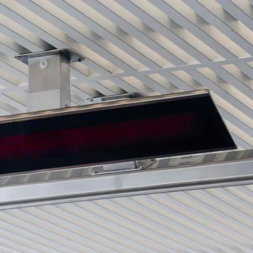 Close-up of modern electric patio heater ceiling-mounted on stainless steel slats