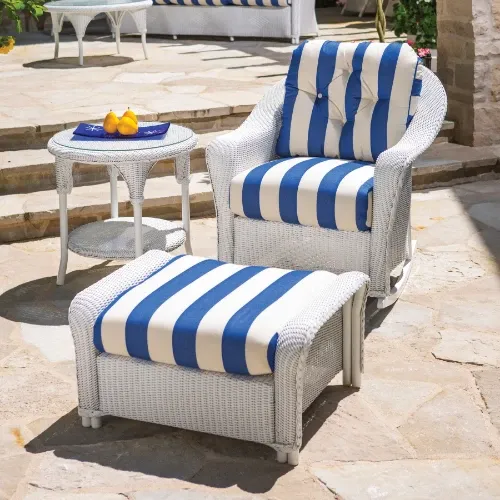 White all-weather wicker armchair and ottoman with blue striped cushions