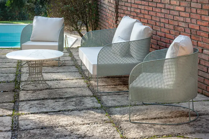 Perforated galvanize steel outdoor lounge furniture near a pool