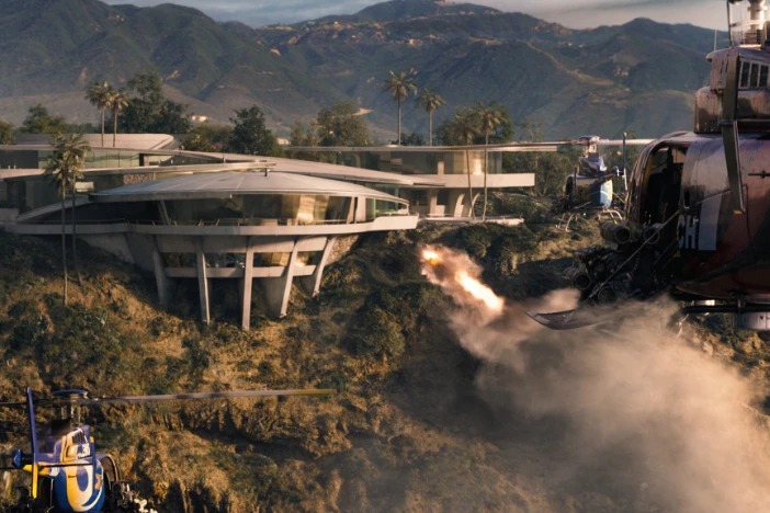Ultra-modern cliffside mansion being attacked with missile fire from helicopters