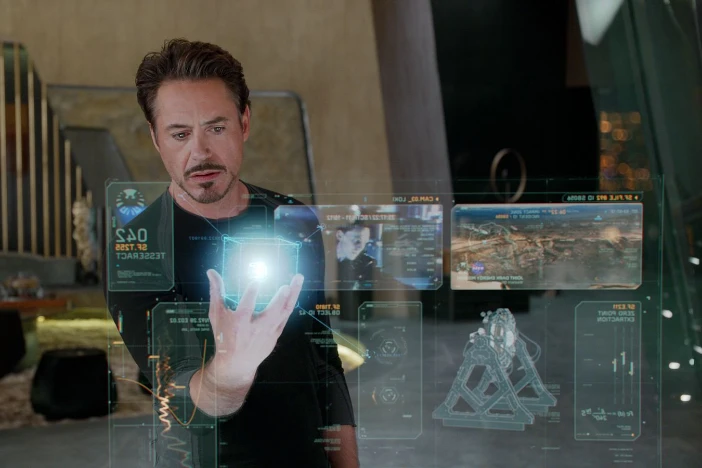 Man with goatee holds a holographic cube in a modern residence