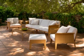 Sleek contemporary patio lounge set with trim caramel brown tight weave wicker frames and thick white upholstery