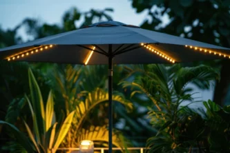 Center pole outdoor umbrella with black canopy and LED lights at dusk in a tropical setting