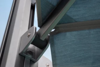 Close-up of grey powder-coated aluminum patio umbrella frame and struts with teal fabric canopy