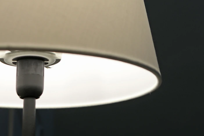 Close-up of light taupe lampshade of black metal lamp