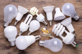 Light bulb in a wide variety of shapes and sizes laying on a wooden table