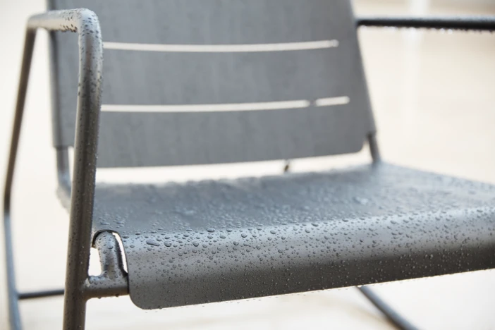 Black powder-coated aluminum outdoor armchair with water beads