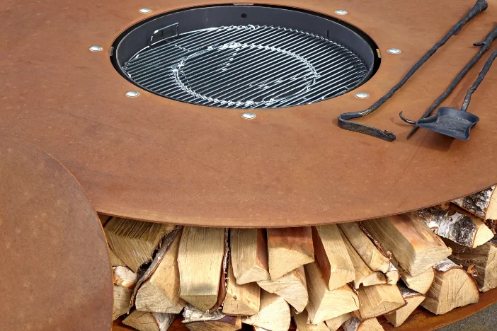 Round oxidized steel fire pit with cover, tools and firewood