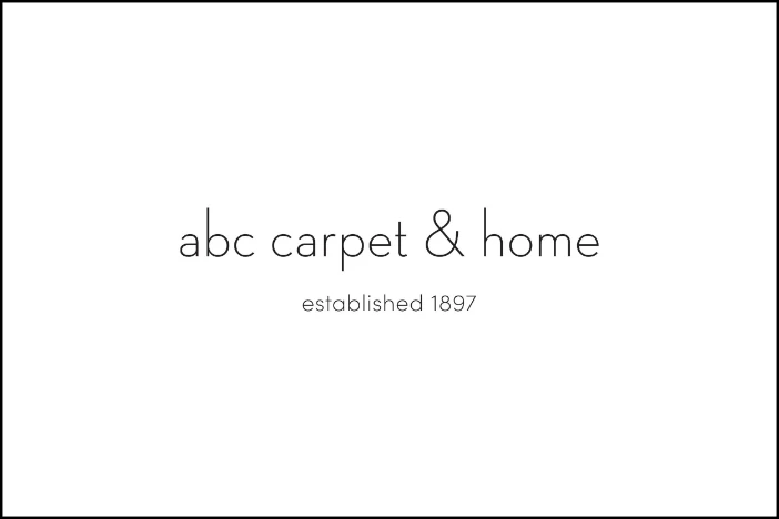 Thin black lowercase sans serif font ABC Carpet & Home logo with founding date on white background