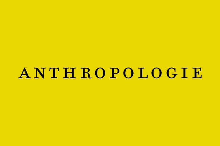 Black uppercase formal font Anthropologie logo on mustard yellow background