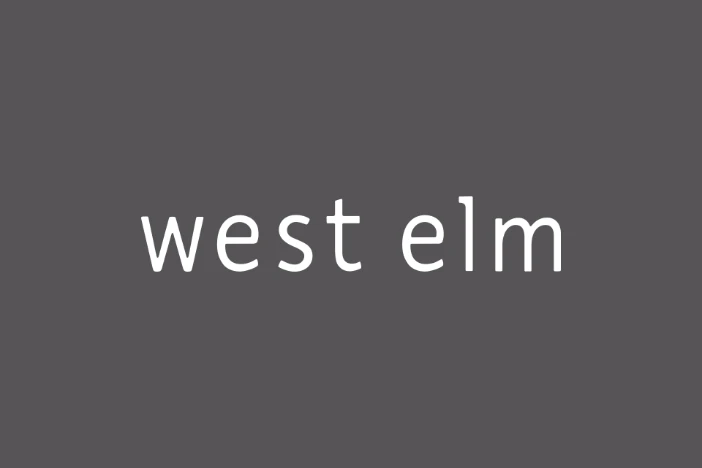 West Elm white text logo on charcoal grey background