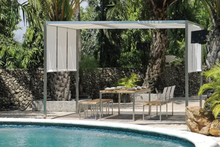Aluminum framed canopy over an outdoor dining set next to a pool