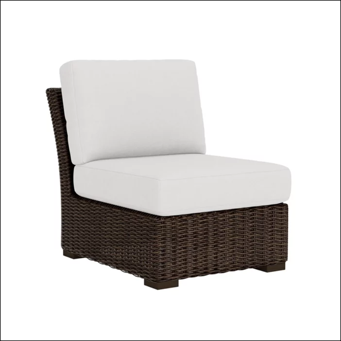 Armless brown outdoor wicker sectional seat with white upholstery