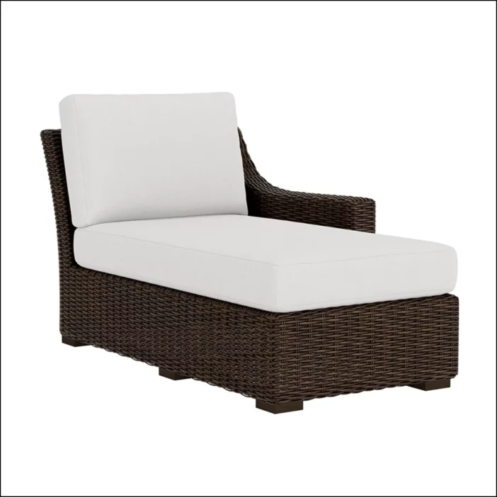 Brown outdoor wicker sectional chaise with white seat and back cushions