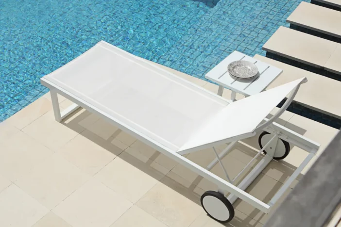 Adjustable white metal sunlounger with mesh sling and wheels