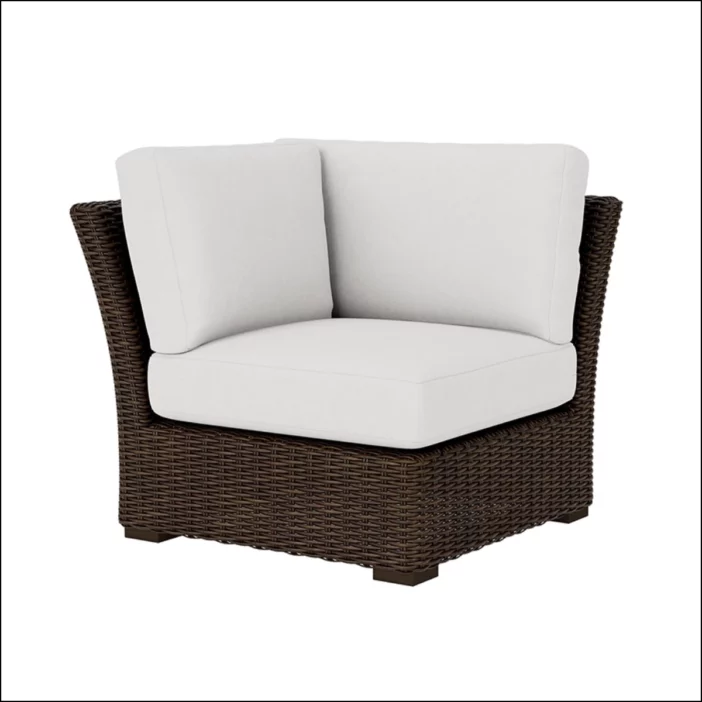 Brown outdoor wicker corner sectional seat with white seat and back cushions