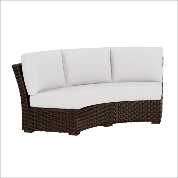 Brown outdoor wicker curved sectional seat with white seat and back cushions