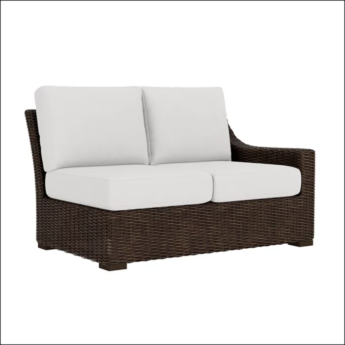 Brown outdoor wicker sectional 2-seater with one arm and white upholstery