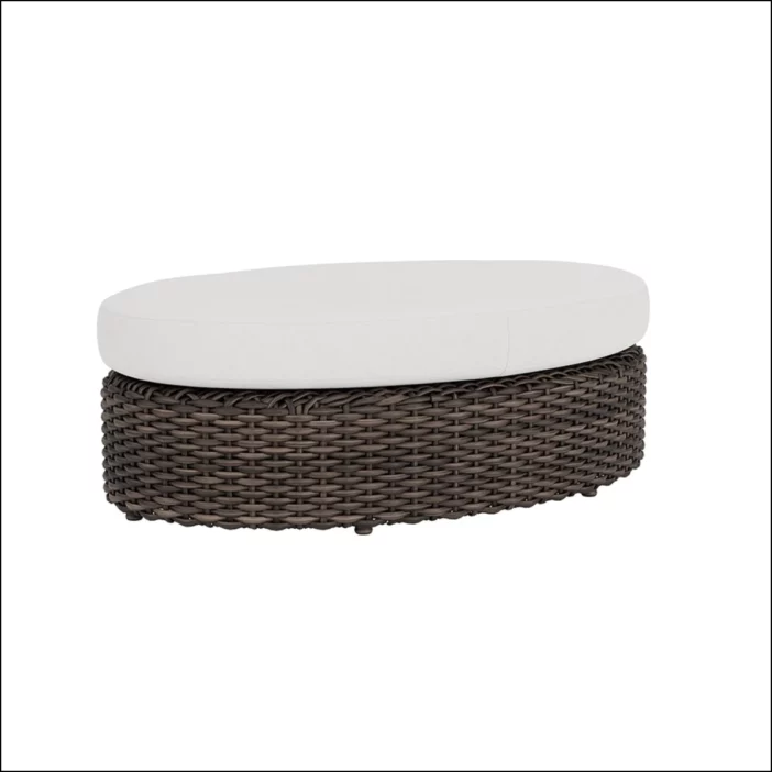 Oval brown outdoor wicker sectional ottoman with white seat cushion