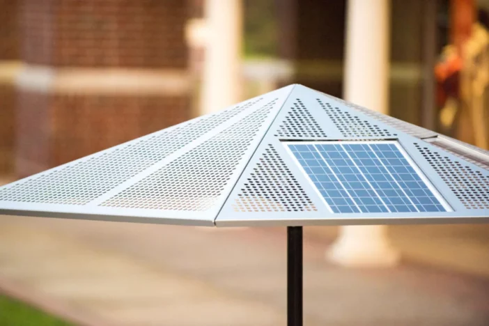 Perforated metal patio umbrella canopy with solar panel
