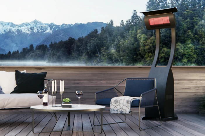 Sleek standing outdoor heater on a furnished hardwood deck with a mountain view