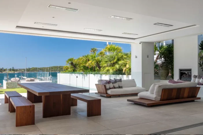 Electric heaters in the ceiling of an open-air patio with modern lounge and dining sets