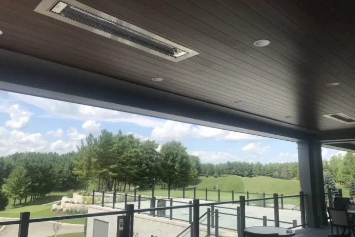 Flush-mounted electric patio heaters in the ceiling of an open air golf course restaurant
