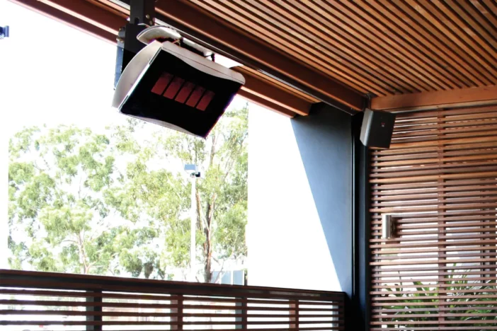 Ceiling-mounted gas heater in an outdoor setting with wood slat design