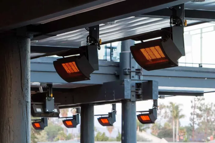 Natural gas heaters on ceiling cross-beams of an industrial outdoor restaurant