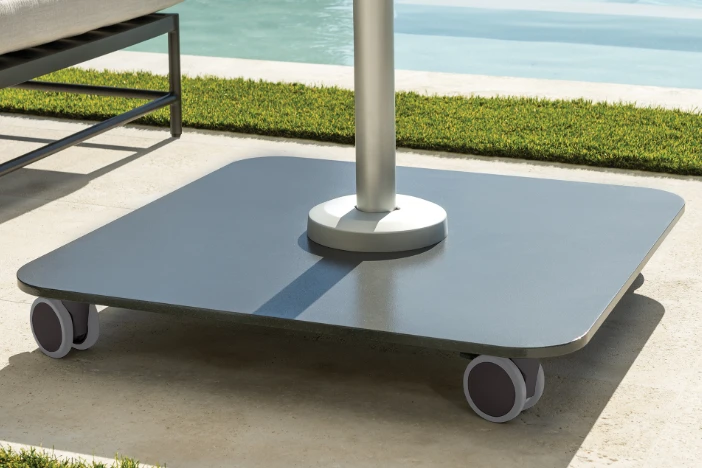 Square dark grey steel plate patio umbrella base with rounded corners and wheels