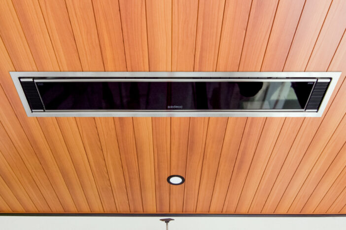 Rectangular Bromic electric patio heater recessed into a wood‑clad covered patio ceiling